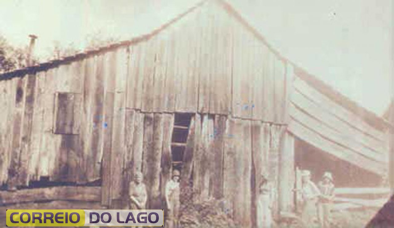 Residência de Bertholdo Gewer, São Vicente Grande, fotografia de 1976. A construção dessa casa remonta ao ano de 1936, tendo como carpinteiro João Tich. Como muitas outras existentes na época, serviu de moradia aos colonos (à esquerda) e também como estrebaria (à direita). O telhado era feito com tabuinhas dada a dificuldade para se obter telhas.